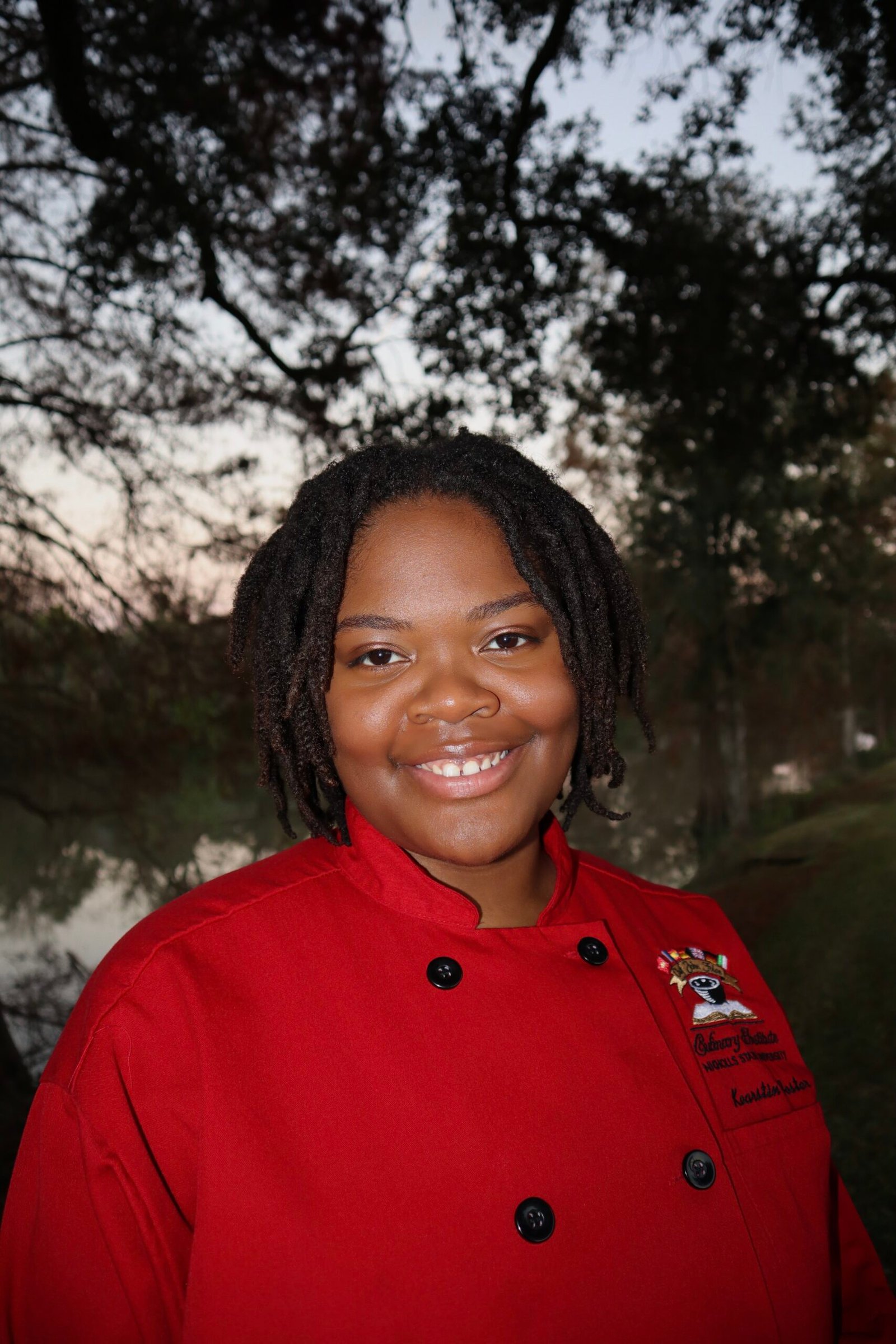 chef in red chef coat headshot